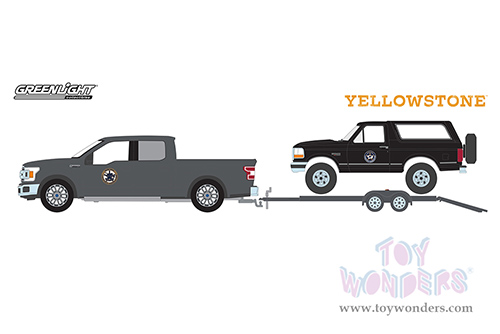 Greenlight - Hollywood Hitch & Tow Series 11 | Yellowstone - Montana Livestock Association 2018 Ford F-150 with 1992 Ford Bronco on Flatbed Trailer (1/64 scale diecast model car, Black) 31150C/24