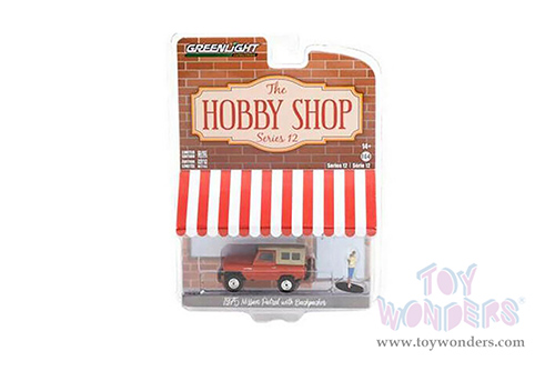 Greenlight - The Hobby Shop Series 12 | Nissan Patrol and Backpacker Figurine (1975, 1/64 scale diecast model car, Orange/Tan) 97120A/48