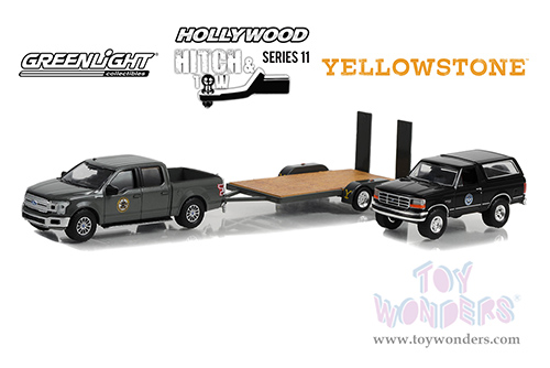 Greenlight - Hollywood Hitch & Tow Series 11 | Yellowstone - Montana Livestock Association 2018 Ford F-150 with 1992 Ford Bronco on Flatbed Trailer (1/64 scale diecast model car, Black) 31150C/24