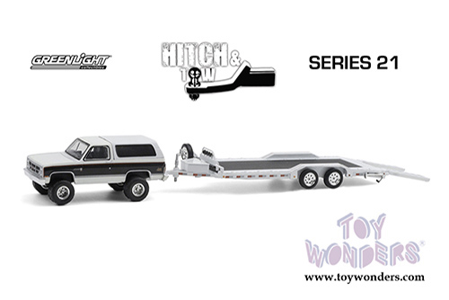 Greenlight - Hitch & Tow Series 21 | GMC&reg; Jimmy Sierra Classic with Heavy Duty Flatbed Car Hauler (1983, 1/64 scale diecast model car, Pearl White/Black) 32210A/24