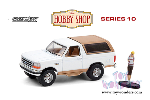 Greenlight - The Hobby Shop Series 10 | Ford Bronco Eddie Bauer with Backpacker (1996, 1/64 scale diecast model car, Oxford White/Light Saddle) 97100F/48